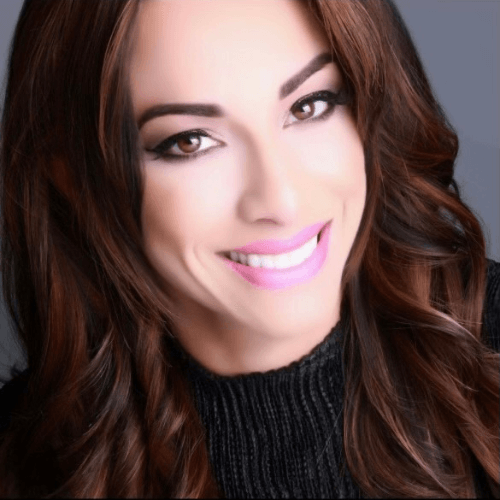 Smiling person with long brown hair.