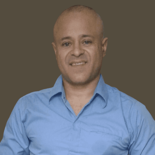 Man smiling in a blue shirt.