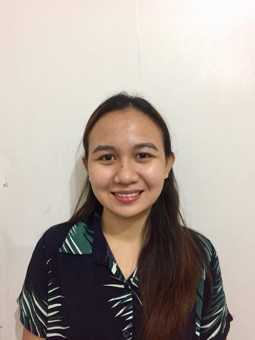 Smiling person against plain background.
