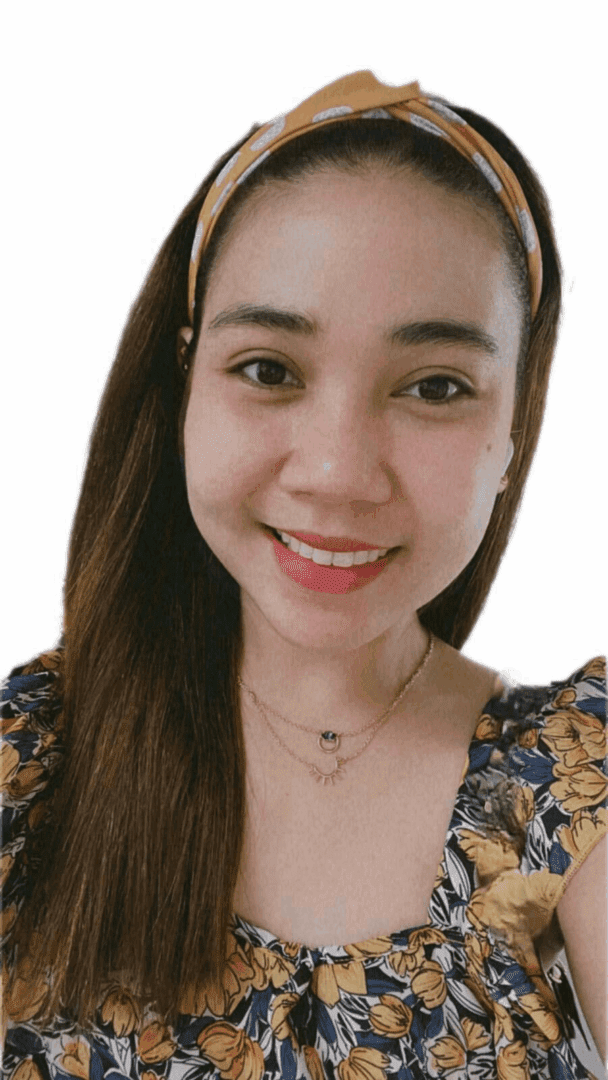 Smiling woman with floral top and headband.